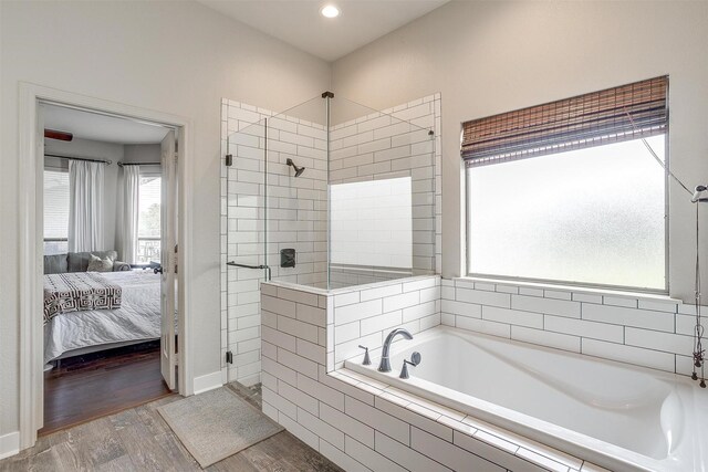 bathroom featuring hardwood / wood-style floors and plus walk in shower