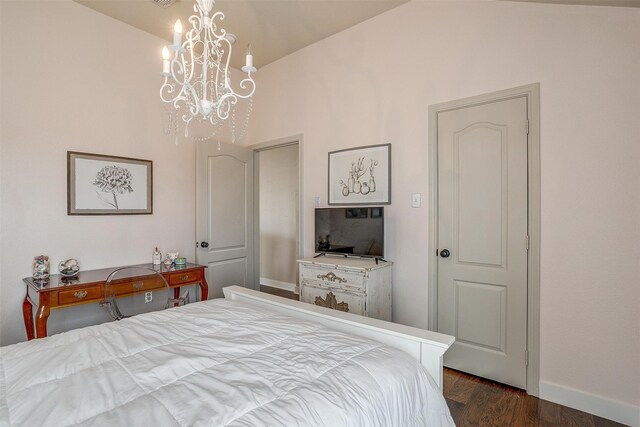 bedroom with an inviting chandelier, dark hardwood / wood-style flooring, and vaulted ceiling