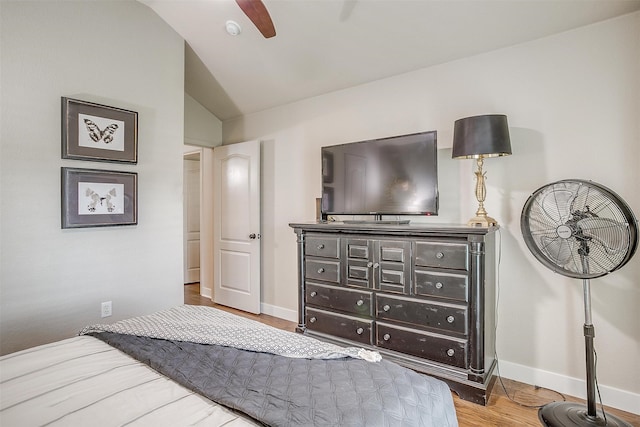 bedroom with vaulted ceiling, light hardwood / wood-style flooring, and ceiling fan