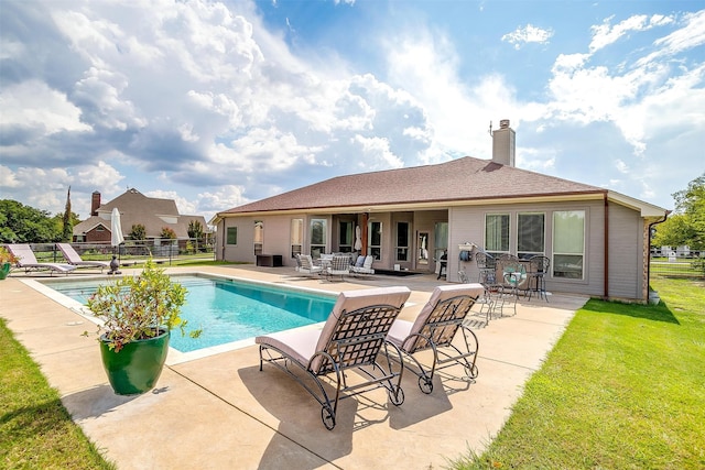 view of swimming pool with a lawn and a patio