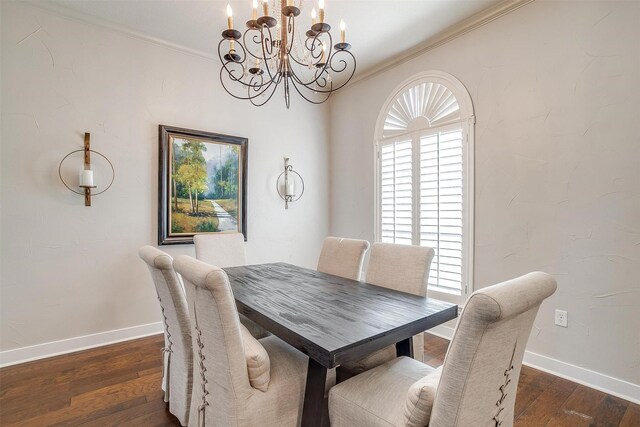 dining space with ornamental molding, an inviting chandelier, and dark hardwood / wood-style flooring