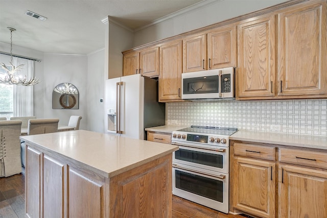 kitchen with dark hardwood / wood-style flooring, pendant lighting, stainless steel appliances, and a chandelier