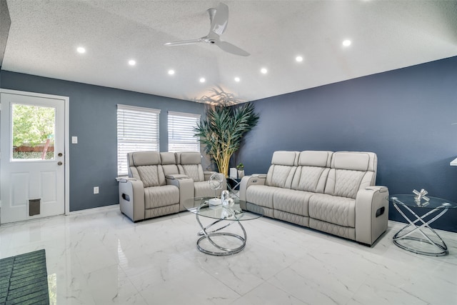 living room with a textured ceiling, a healthy amount of sunlight, and ceiling fan