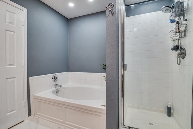 bathroom with a textured ceiling and plus walk in shower