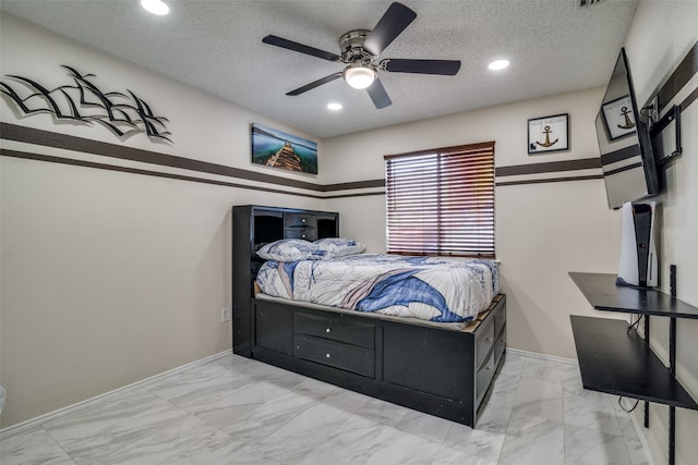 bedroom with a textured ceiling and ceiling fan