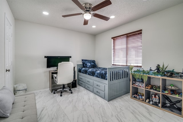 bedroom with a textured ceiling and ceiling fan