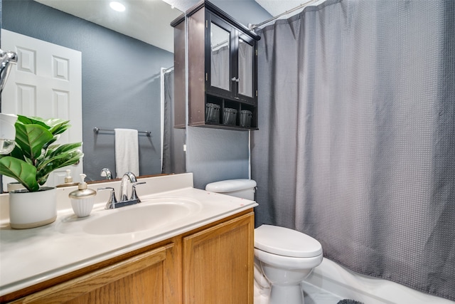 full bathroom featuring vanity, toilet, and shower / tub combo with curtain