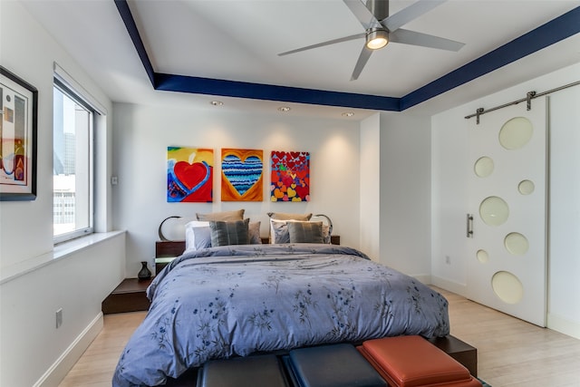 bedroom with ceiling fan and light hardwood / wood-style floors