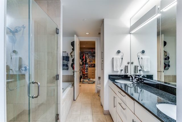 full bathroom with vanity, toilet, plus walk in shower, and tile patterned floors