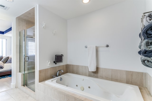 bathroom with independent shower and bath and tile patterned floors