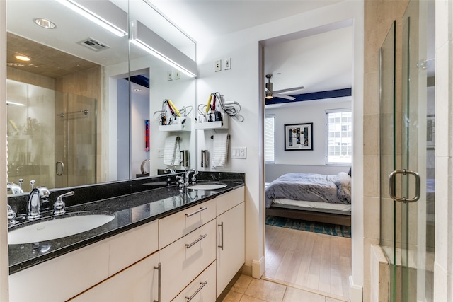 bathroom featuring hardwood / wood-style floors, ceiling fan, vanity, and a shower with shower door