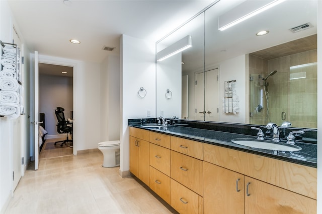 bathroom featuring vanity, toilet, walk in shower, and tile patterned floors