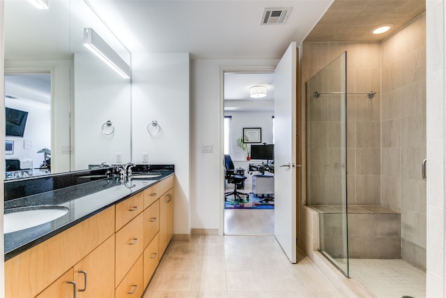 bathroom with vanity, an enclosed shower, and tile patterned flooring