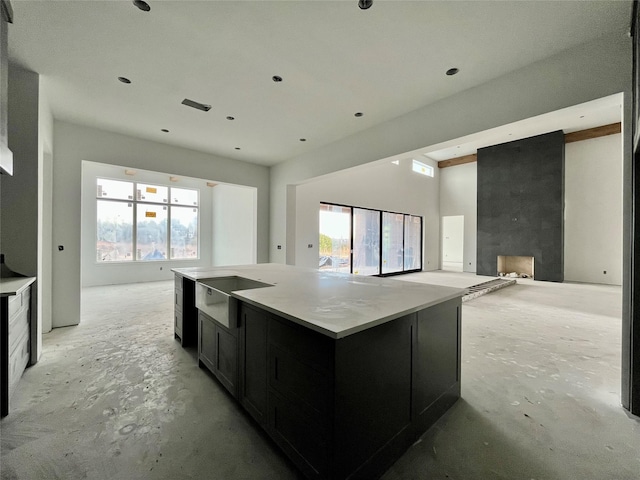 kitchen with light stone countertops and a spacious island