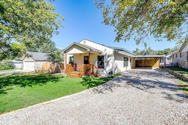 view of front of property featuring cooling unit, a garage, a front yard, a porch, and a carport