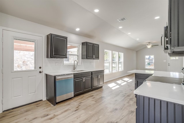 kitchen featuring a healthy amount of sunlight, lofted ceiling, dishwasher, and ceiling fan