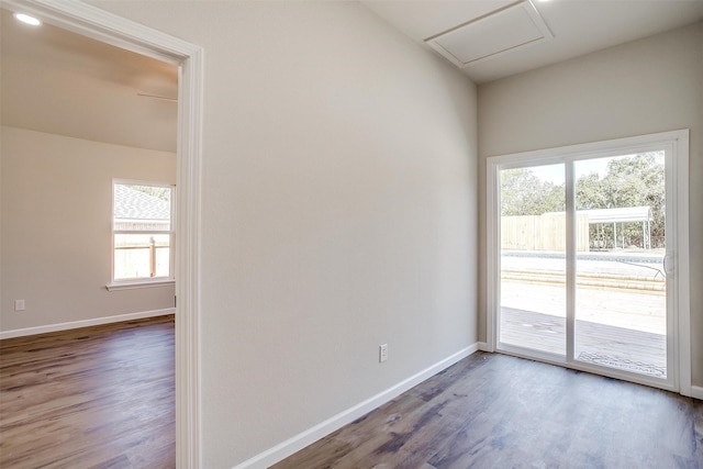 spare room featuring plenty of natural light and dark hardwood / wood-style floors