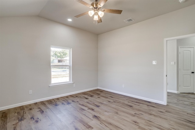 empty room featuring ceiling fan, lofted ceiling, and light hardwood / wood-style floors