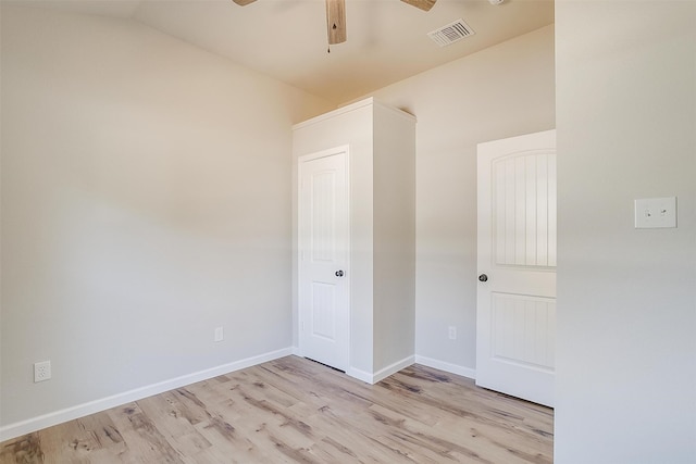 unfurnished room featuring ceiling fan, light wood-type flooring, and lofted ceiling