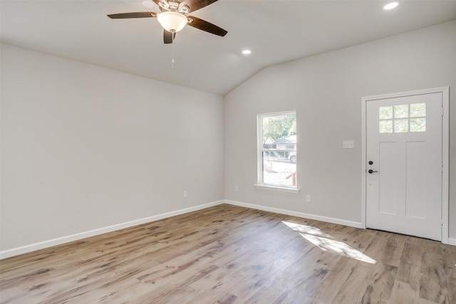 foyer entrance featuring light hardwood / wood-style flooring, vaulted ceiling, ceiling fan, and a healthy amount of sunlight