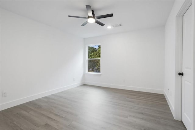 empty room featuring ceiling fan and hardwood / wood-style flooring