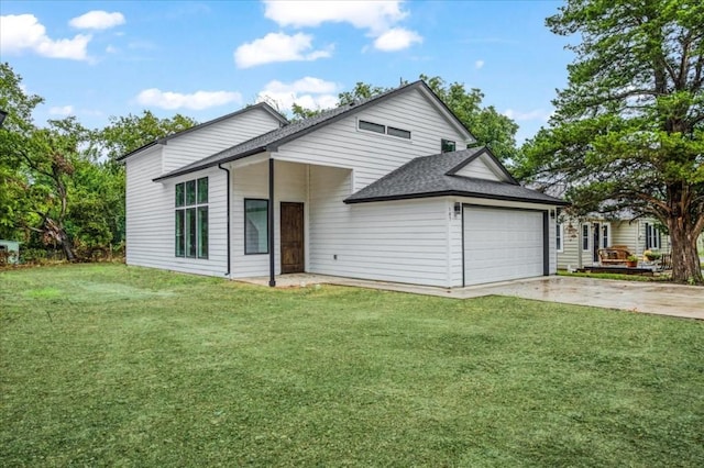 view of front of house with a garage and a front yard