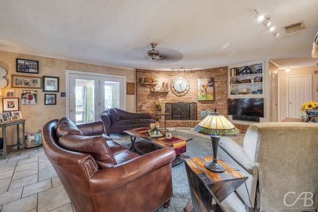 living room featuring ornamental molding, a textured ceiling, and ceiling fan