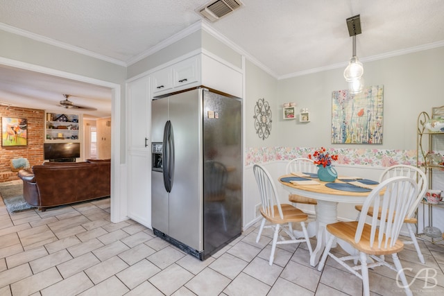 kitchen with crown molding, a textured ceiling, decorative light fixtures, stainless steel fridge with ice dispenser, and white cabinets