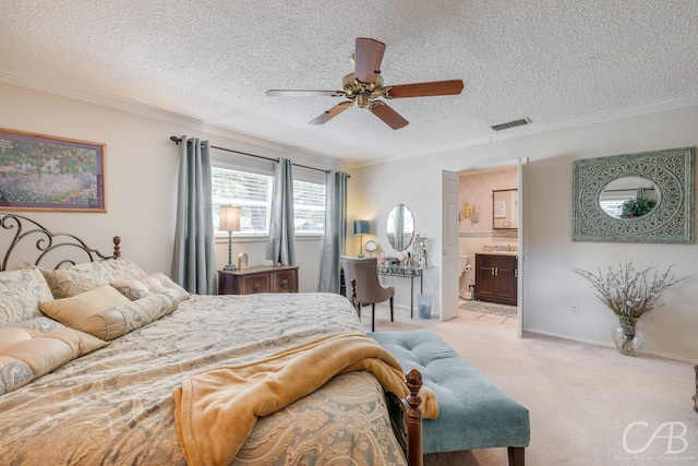 carpeted bedroom with ornamental molding, a textured ceiling, ensuite bathroom, and ceiling fan