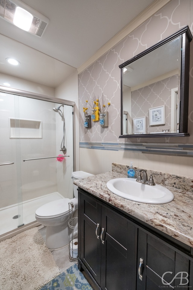 bathroom featuring crown molding, toilet, a shower with shower door, tasteful backsplash, and vanity