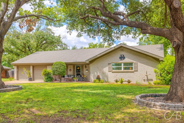 ranch-style house with a front yard and a garage