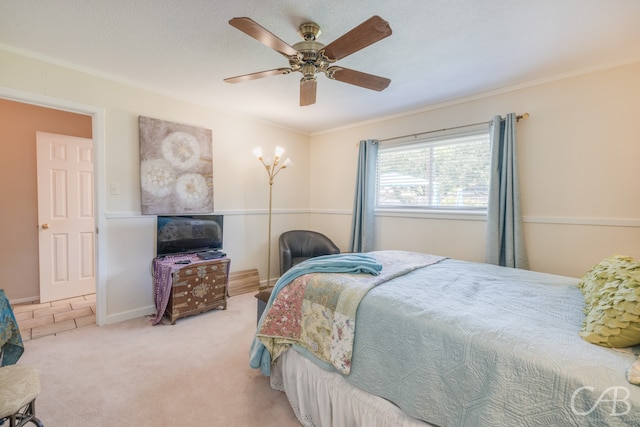 bedroom with carpet flooring, ceiling fan, crown molding, and a textured ceiling