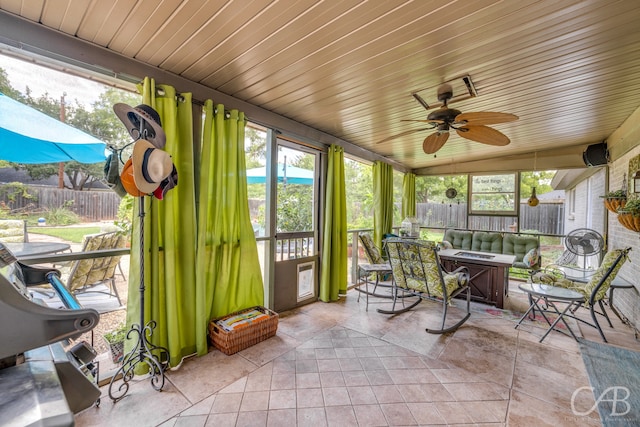 sunroom with lofted ceiling, plenty of natural light, and wooden ceiling