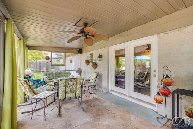 sunroom / solarium with ceiling fan and wooden ceiling