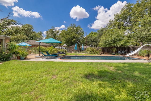 view of yard with a fenced in pool and a patio area