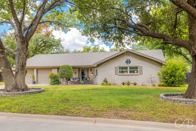 ranch-style house featuring a garage and a front yard