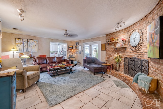 living room with a textured ceiling, rail lighting, light tile patterned floors, ceiling fan, and french doors