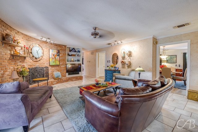 living room featuring ornamental molding, rail lighting, light tile patterned flooring, and ceiling fan