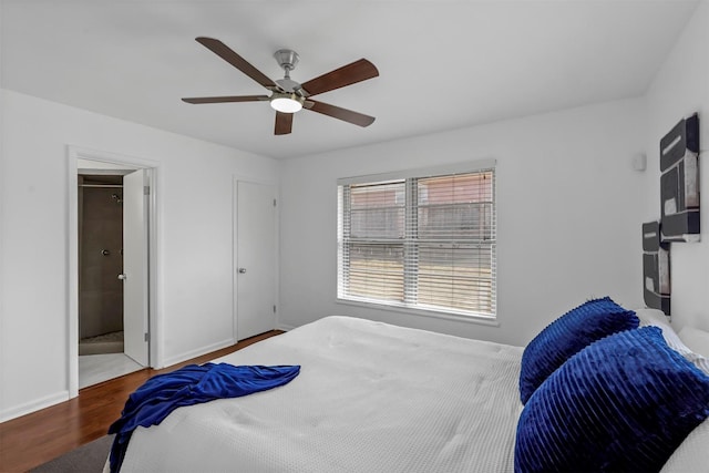 bedroom featuring ceiling fan, ensuite bathroom, and hardwood / wood-style flooring