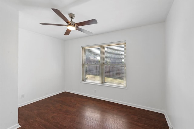 empty room with ceiling fan and dark hardwood / wood-style floors