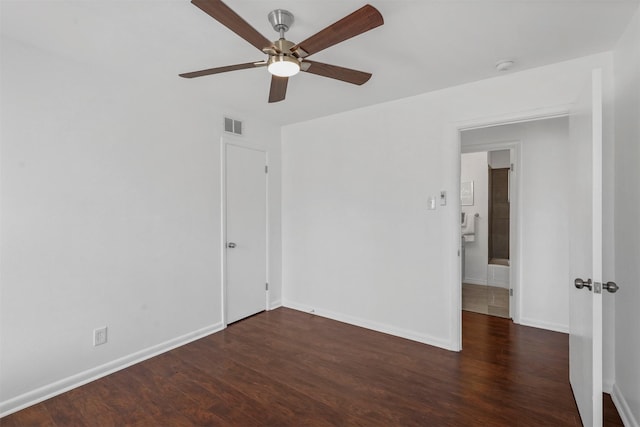 empty room featuring ceiling fan and dark hardwood / wood-style flooring