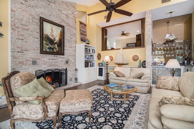 living room with a fireplace, hardwood / wood-style floors, and ceiling fan