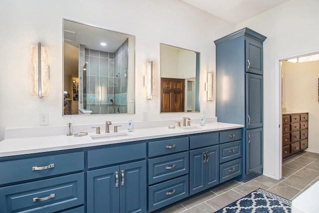 bathroom featuring tile patterned floors, walk in shower, and vanity