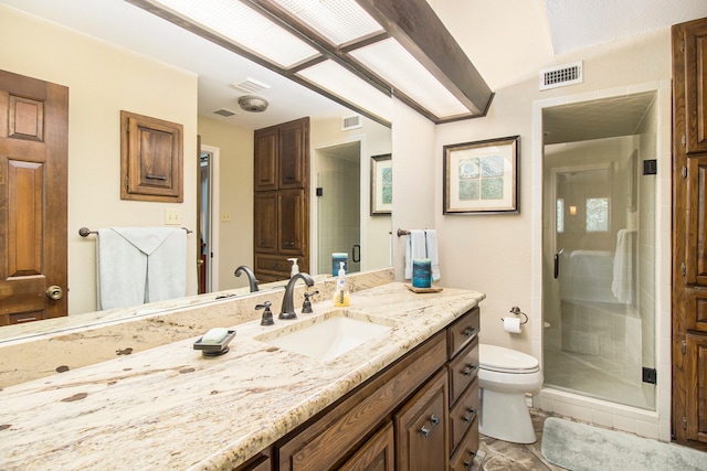 bathroom featuring vanity, tile patterned flooring, toilet, and an enclosed shower