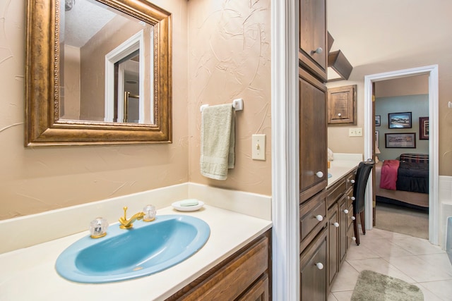 bathroom with tile patterned flooring, a textured ceiling, and vanity