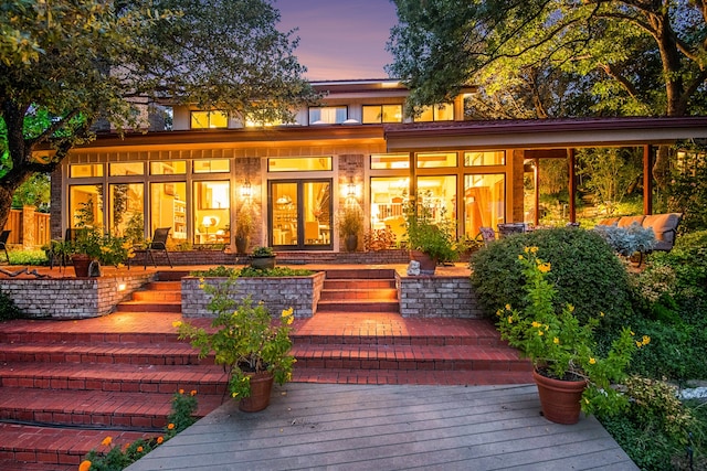 view of back house at dusk