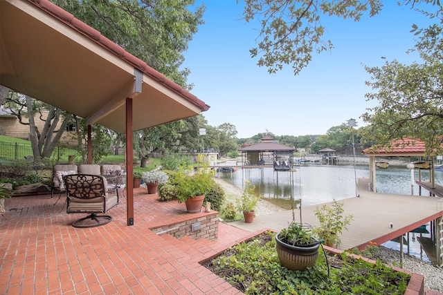 view of patio featuring a dock and a water view