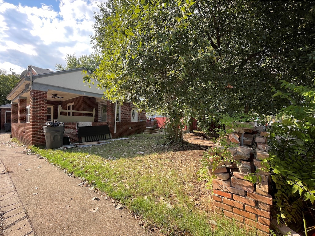 view of yard with an outdoor living space, ceiling fan, and a patio area