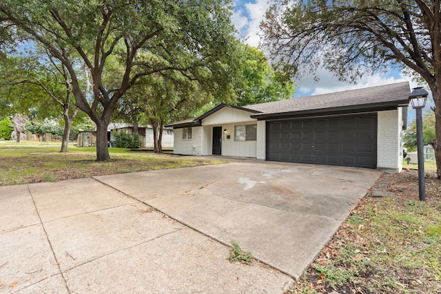 ranch-style house featuring a garage and a front yard