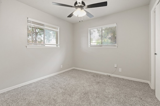 carpeted spare room with ceiling fan and a healthy amount of sunlight